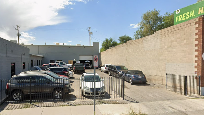 The Los Oviedo Garage and Sales lot on South State Street with vehicles parked behind the gate and an open service bay